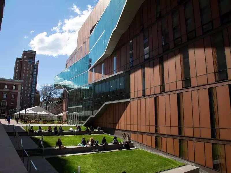 students sitting on outdoor campus stairs